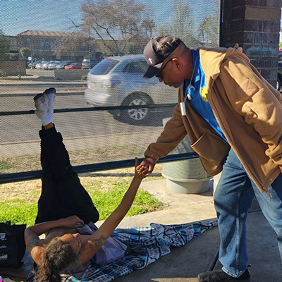 Volunteer helping homeless man
